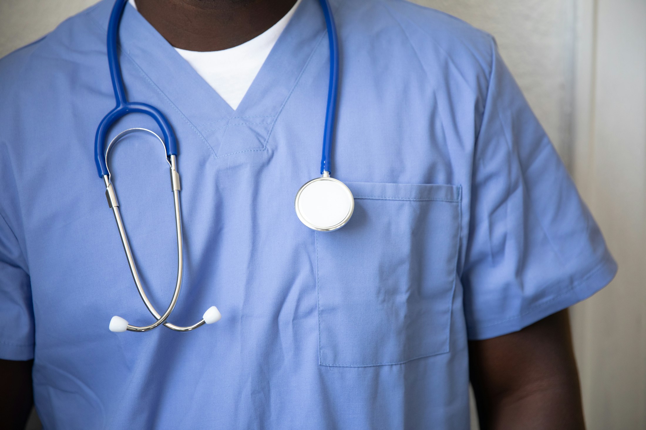 Black healthcare facility administrator walking through a hospital